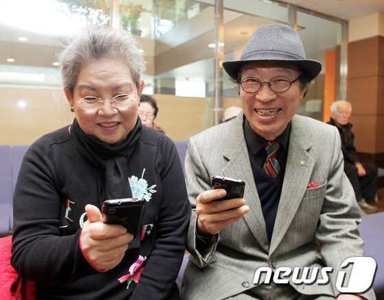 어르신들이 휴대폰을 보며 즐거워하고 있다.(SK텔레콤 제공) © News1