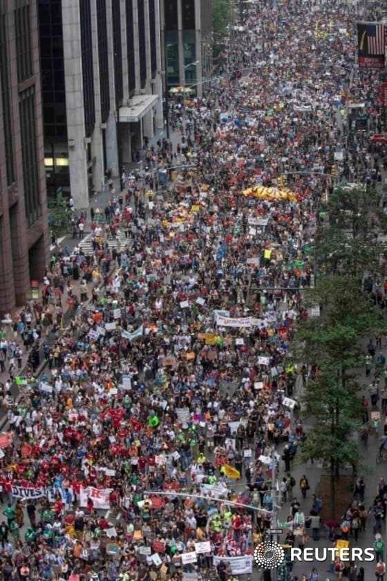 Tens of thousands march down 6th Avenue while taking part in the People