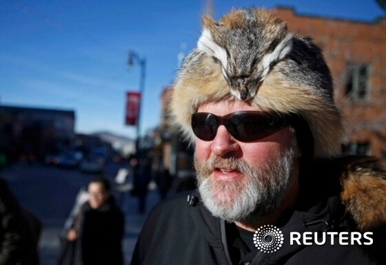 Steve Forbes wears a hat made from a fox on Main Street on the first day of Sundance Film Festival in Park City, Utah