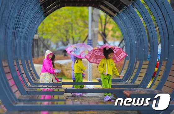 부산 시민공원을 찾은 아이들이 우산을 쓰고 현장학습을 하고 있다.뉴스1 © News1 이승배 기자