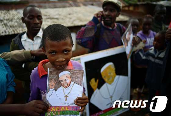 케냐 빈미낙 강게미시에 사는 어린이가 교황을 그린 그림을 들고 그의 방문을 기다리고 있다.© AFP=뉴스1