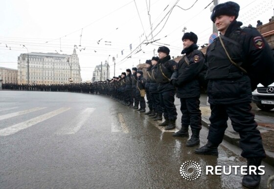 Riot police stand guard during a march to commemorate Kremlin critic Nemtsov in central Moscow