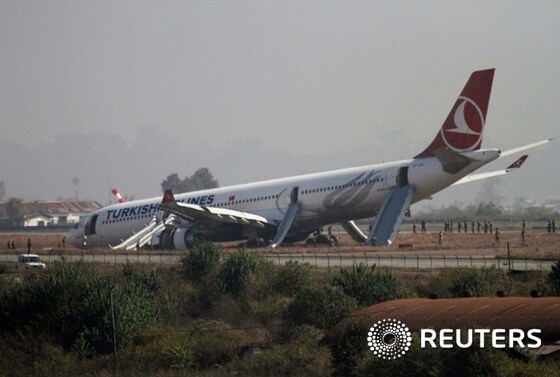 A Turkish Airlines plane lies on the field after it overshot the runway at Tribhuvan International Airport in Kathmandu
