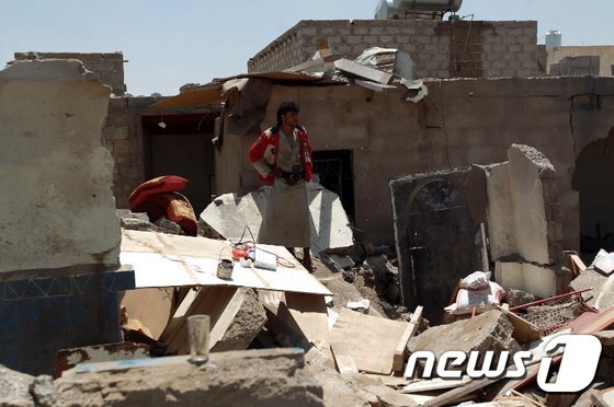 한 예멘 사나 주민이 31일(현지시간) 사우디아라비아 주도 연합군의 공습으로 파괴된 집을 바라보며 망연자실한 표정을 짓고 있다.© AFP=뉴스1