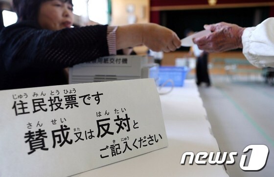 일본 오사카 시민들이 17일 오사카시를 폐지하고 오사카도와 산하 5개 특별 행정구로 재편하는 ´오사카도 구상´에 대한 찬반 주민투표에 참여하고 있다. 오사카도 구상은 투표결과 찬성 49.6%, 반대 50.4%로 부결됐다.© AFP=뉴스1