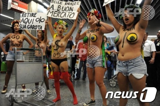 여성인권단체 ‘페멘 브라질(Femen Brazil)’ 소속 시위자들이 상의를 벗은 채 리우데자네이루 갈레앙 국제 공항에서 ‘섹스관광’에 반대하는 시위를 벌이고 있다. 사진은 2013년 2월 8일에 찍었다. © AFP=뉴스1