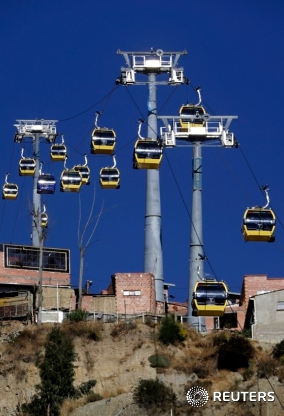 Cable cars pass over El Alto