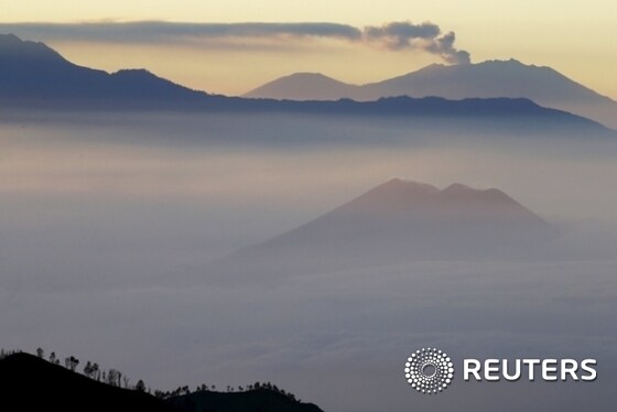 Mount Raung spews ash into the air, as seen from Mount Bromo