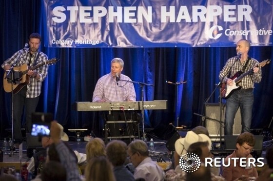 Canadian PM Harper plays with his band the Van Cats for supporters at his annual Stampede BBQ during the Calgary Stampede.