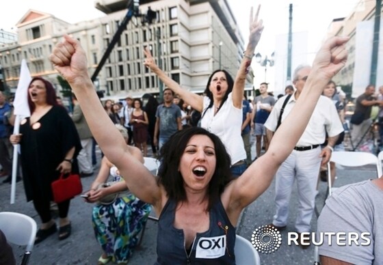 5일 그리스 아테네에서 국민투표의 초기 출구조사가 나오자 한 여성이 긴축반대를 외치며 환호하고 있다. 