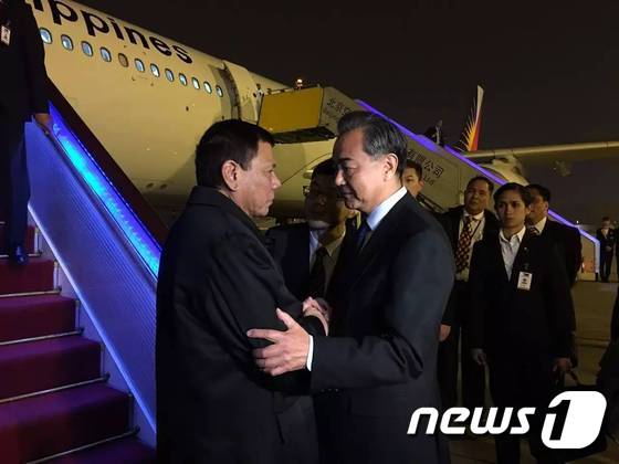 로드리고 두테르테 필리핀 대통령이 18일(현지시간) 저녁 중국 베이징에 도착해 왕이 외교부장의 인사를 받고 있다. (사진출처 CCTV)© News1