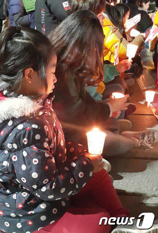 12일 오후 5시 국정농단규탄 태백시민 촛불문화제가 강원 태백시 황지연못에서 열린 가운데 한 아이가 촛불을 들고 있다. 2016.11.12./뉴스1 © News1 하중천 기자