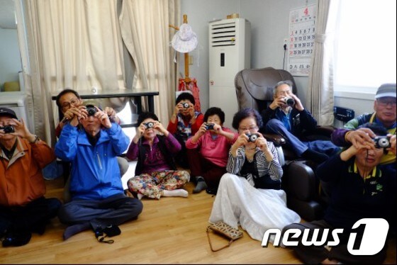 청자마을 주민들이 대덕문화원의 문화 활동가 양성사업의 일환으로 임대한 카메라를 나눠주자 카메라를 신기한 듯 바라보고 있다. (대덕문화원 제공) © News1