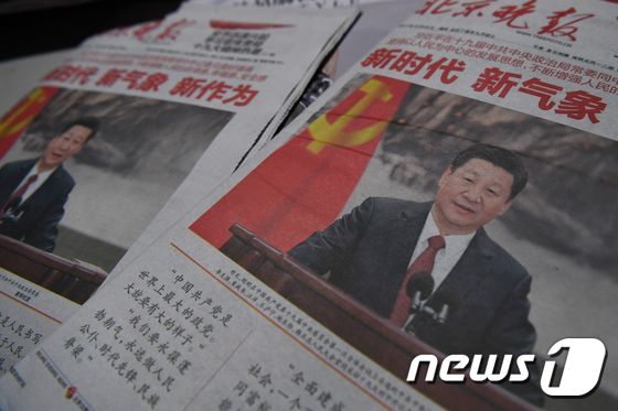 중국의 새 정치국 상임위원회 출범 다음 날인 26일  베이징의 가판대에 시진핑 국가주석이 사진으로 메운 신문이 펼쳐져 있다. © AFP=뉴스1