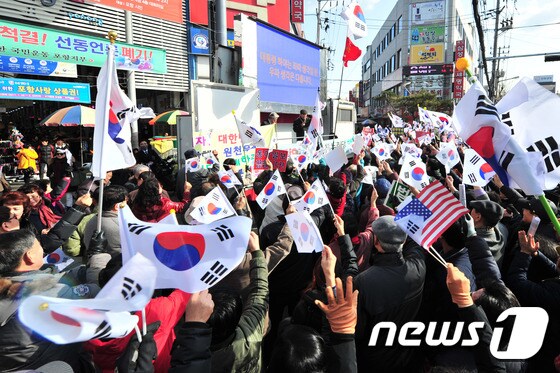 7일 오후 경북 포항시 죽도시장에서 열린 박근혜 대통령 탄핵 기각 범 시민궐기대회에서 보수단체 회원 등 300여명이 태극기를 흔들고 있다. 이날 집회에서 서경석 새로운 한국을 위한 국민운동 집행위원장 등은 