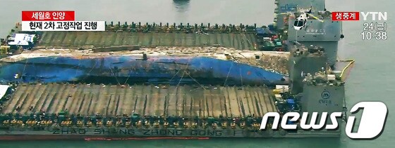 24일 오전 세월호 침몰 해역인 전남 진도군 동거차도 앞바다에서 중국 인양업체인 상하이샐비지사 소속 인양 선원들이 세월호 인양작업을 진행하고 있다. 문제가 됐던 세월호 선미램프 제거 작업은 완료됐다. (YTN 캡처) 2017.3.24/뉴스1