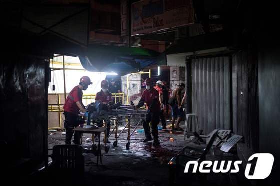 28일(현지시간) 필리핀 마닐라에서 폭탄이 터져 구조 대원들이 구조 작업을 벌이고 있다. © AFP=뉴스1
