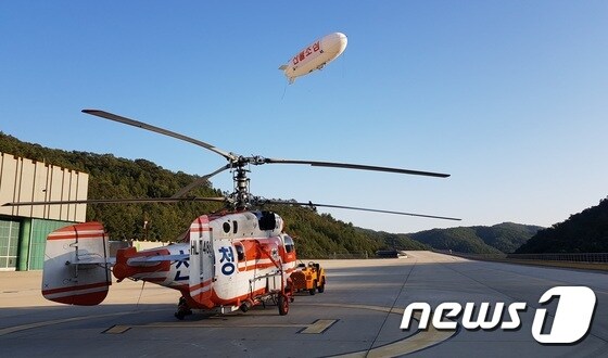 스카이십이 산불 감시활동을 벌이고 있는 가운데 산림항공본부의 산림 헬기가 출동 준비를 하고 있는 모습(KT 제공)© News1