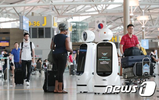 외국인 관광객이 인천국제공항에서 안내로봇 '에어스타'를 체험하고 있다.(특정 기사 내용과 관계 없음)