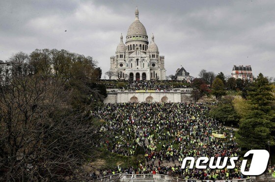 프랑스 '노란조끼' 시위대가 23일(현지시간) 오후 파리 시내 행진을 마치고 몽마르트르 거리 사크르쾨르 성장 앞에 모여 있다. © AFP=뉴스1