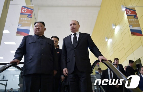 김정은 북한 국무위원장(왼쪽)과 블라디미르 푸틴 러시아 대통령이 지난 25일 정상회담이 열린 블라디보스토크 소재 극동연방대 건물 안에서 함께 이동 중이다. © 로이터=뉴스1