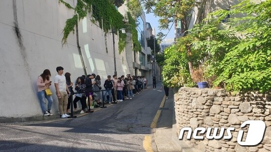 22일 오전, 서울 강남구 인앤아웃 버거 팝업스토어를 기다리는 사람들. 다른 골목까지 길게 줄을 서 있다. © 뉴스1