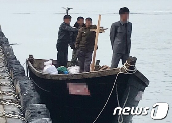 지난 15일 북한 선원 4명이 탄 어선이 연안에서 조업 중인 어민의 신고로 발견됐다는 정부 당국의 발표와 달리 삼척항 부두에 정박했다고 KBS가 18일 보도했다. 사진은 당시 삼척항 부두에 정박한 북한어선과 어민. (독자 제공) 2019.6.19/뉴스1
