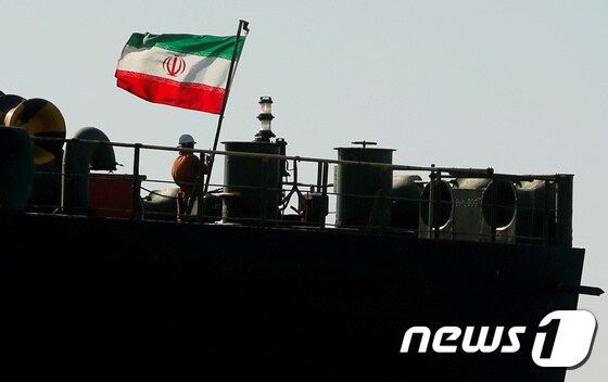 18일(현지시간) 영국령 지브롤터 해상에 머물고 있는 이란 유조선 '아드리안 다르야 1호' 갑판 위에서 승조원이 이란 국기를 게양하고 있다. © 로이터=뉴스1 © News1 이원준 기자