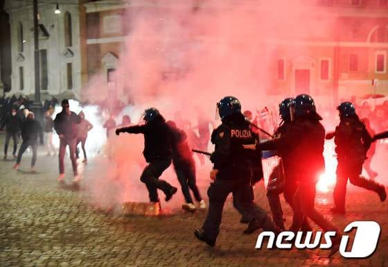 24일(현지시간) 이탈리아 수도 로마 포폴로 광장에서 정부 방역 방침에 항의하는 시위대와 경찰이 충돌하고 있다. © AFP=뉴스1