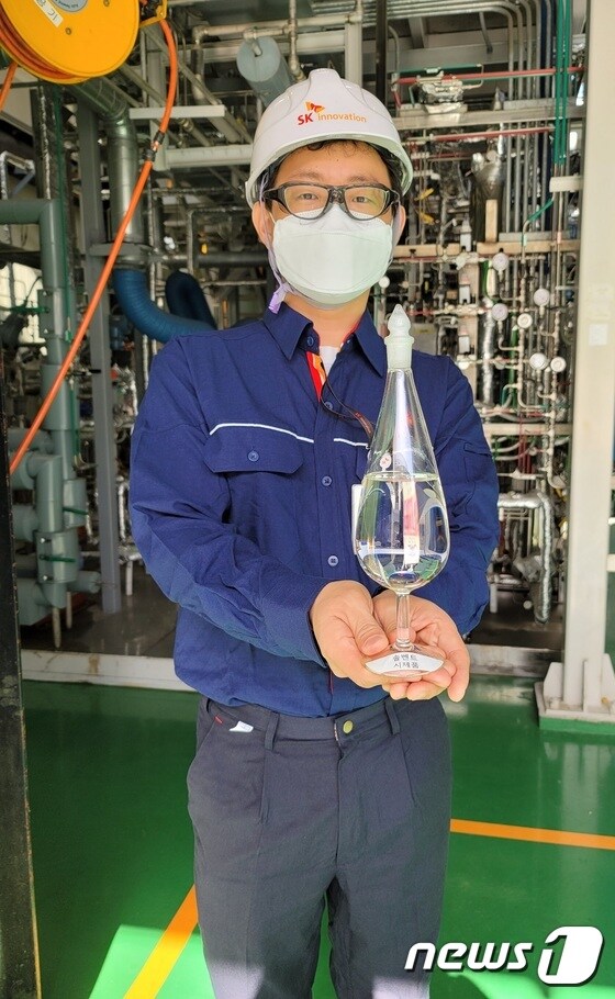 지난 2일 대전 유성구 소재 SK이노베이션 기술혁신연구원에서 만난 이호원 수석 연구원(36)이 폐플라스틱 열분해유 시제품 생산시설 앞에서 제품을 들어보이고 있다. © 뉴스1