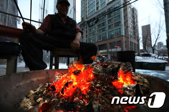  17일 오전 서울 중구 중림시장에서 상인들이 모닥불을 쬐고 있다. 2020.2.17/뉴스1 © News1 민경석 기자