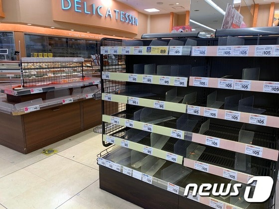 일본 도쿄 소재 한 슈퍼마켓의 육류 등 식료품 선반이 25일 시민들의 '사재기'로 비워져 있다. (대니얼 롭슨 트위터) © 뉴스1