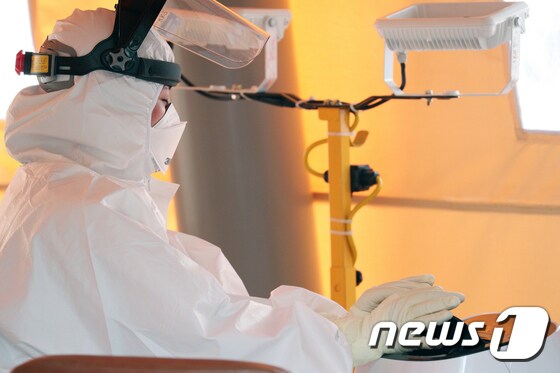 7일 서울 양천구 보건소 선별진료소에서 의료진이 더위를 식히고 있다. 뉴스1 © News1 황기선 기자