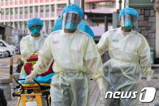 홍콩의 한 병원에서 보호복을 입은 의료진들이 코로나19 환자를 이송하고 있다.© AFP=뉴스1