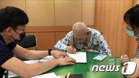 강원준씨가 초록우산어린이재단의 유산기부자 모임인 그린레거시클럽 가입서를 작성하고 있다.(어린이재단 제공)© 뉴스1