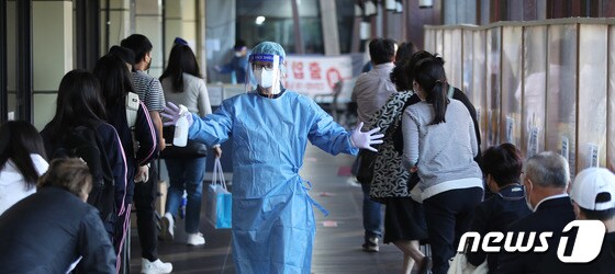 13일 오전 서울 송파구보건소에 마련된 신종 코로나바이러스 감염증(코로나19) 선별진료소를 찾은 시민들이 검사를 위해 의료진의 안내를 받아 이동하고 있다.  2021.10.13/뉴스1 