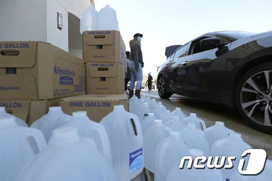 20일(현지시간) 한파로 인해 피해를 입은 미국 텍사스주 휴스턴에서 자원봉사자들이 주민들에게 식수를 배급할 준비를 하고 있다. © AFP=뉴스1