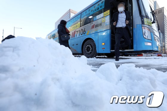 수도권을 중심으로 많은 눈이 내린 2021년 2월 4일 오전 서울 광화문버스 정류장에서 시민들이 출근길 발걸음을 재촉하고 있다. 2021.2.4/뉴스1 © News1 황기선 기자