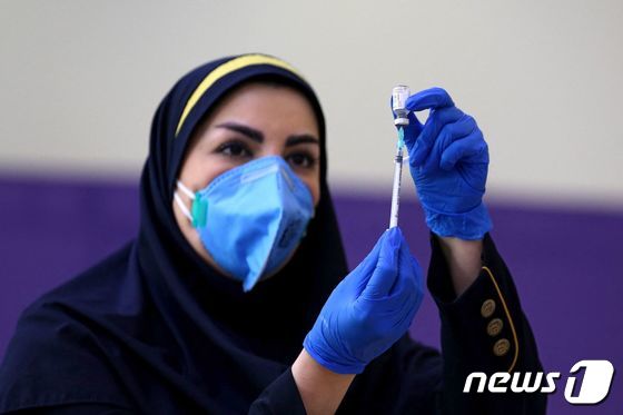 이란에서 한 의료진이 코로나19 백신 접종을 준비하고 있다. © AFP=뉴스1