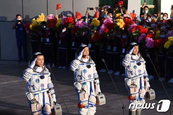 중국 우주인 녜하이성, 탕훙보, 류보밍이 17일(현지시간) 간쑤성 주취안 위성발사센터에서 창정-2F 야오-12 로켓에 실려 발사될 유인우주선 선저우 12호에 탑승하기 전 경례를 하고 있다. © AFP=뉴스1 © News1 우동명 기자