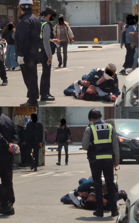 한 누리꾼이 경찰의 주취자 대응 현장을 찍어 공개했다. 남경은 대상을 제압하고 있고 여경은 현장을 촬영하고 있다. (보배드림 갈무리) © 뉴스1