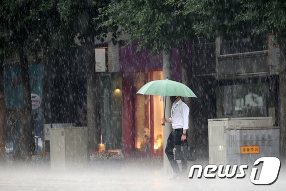 15일 오후 대구 중구 공평네거리에서 갑작스레 소나기를 만난 시민들이 쏟아지는 비를 피해 발걸음을 재촉하고 있다. 2021.7.15/뉴스1 © News1 공정식 기자
