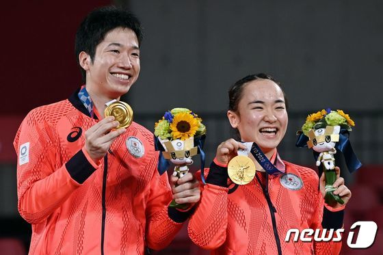 일본 탁구서 올림픽 역사상 첫 금메달을 획득한 미즈타니 준-이마 조가 금메달을 획득한 뒤 기뻐하고 있다. © AFP=뉴스1