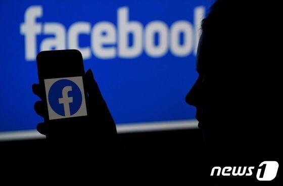 (FILES) In this file illustration photo taken on April 7, 2021, a smart phone screen displays the logo of Facebook on a Facebook website background, in Arlington, Virginia. (Photo by OLIVIER DOULIERY / AFP) © AFP=뉴스1