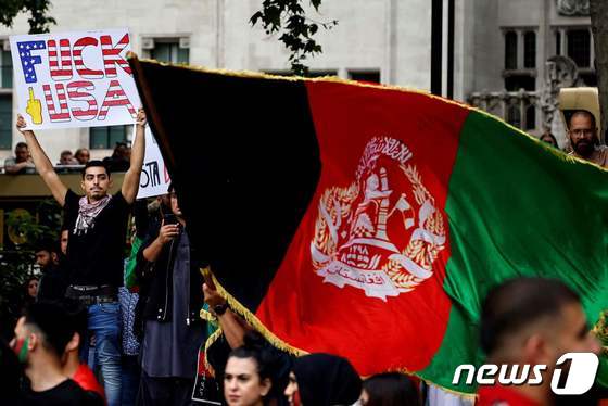 21일(현재시간) 영국 런던 소재 의회 광장에서 시위자들이 아프가니스탄 국가를 들고 있다.(본문과 관련없음) 2021.08.21 © AFP=뉴스1