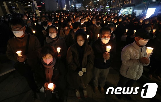  서울파이낸스센터 앞에서 천주교정의구현전국사제단 주최로 열린 이태원 참사 희생자 추모미사에서 시민들이 촛불을 들고 있다. 2022.11.14/뉴스1 © News1 박세연 기자