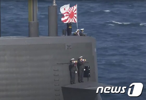 일본 해상자위대 주최로 6일 가나가와현 사가미만에서 열린 국제관함식에서 해상자위대기(자위함기)를 단 일본 잠수함이 항행하고 있다. 자위함기는 일제의 태평양전쟁 당시 군기이자 군국주의 상징인 욱일기를 계승한 것이다. (일본 해상자위대 유튜브 캡처)  © News1 