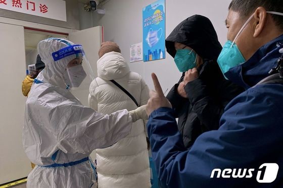 지난 22일 중국 충칭대 의대 제1부속병원 진료소에서 의료진이 환자들을 안내하고 있다. 2022.12.22. © AFP=뉴스1