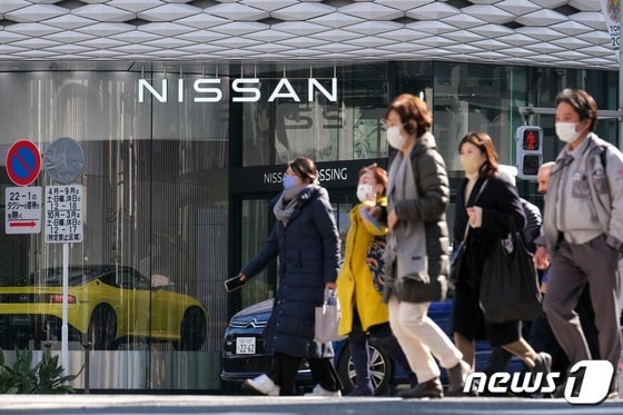 도쿄 도민들이 2022년 2월 8일(현지시간) 도쿄 긴자 지구에서 닛산자동차의 전시장을 지나가고 있다. © AFP=뉴스1 © News1 김지현 기자