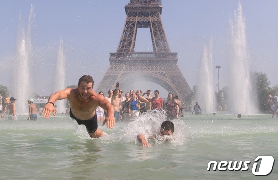 유럽 대륙에 섭씨 40도를 웃도는 기록적인 폭염이 이어지는 가운데 19일(현지시간) 프랑스 파리에서 시민들과 관광객들이 에펠탑 샤요궁 앞 분수대에 들어가 더위를 식히고 있다.  2022.7.20/뉴스1. © News1 이준성 프리랜서기자